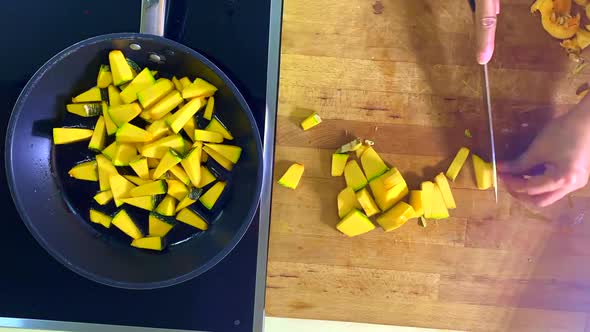 Time lapse  of an Asian kind Young pumpkin being cut or slice and saute on a pan then added into gre