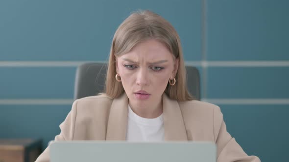 Close Up of Businesswoman Reacting to Loss While Using Laptop