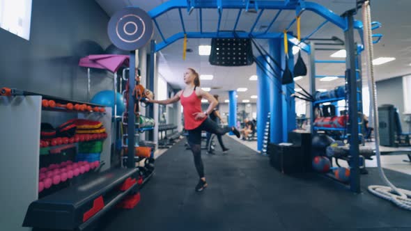 Young woman doing exercise in the sports gym.