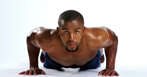 Fit man exercising on white background 4k