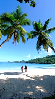 Anse Takamaka Beach Mahe Seychelles Tropical Beach with Palm Trees and a Blue Ocean Couple Man and