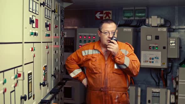 Marine Engineer Working on Radio Communication at Engine Control Room