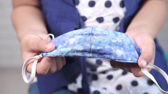 Child Hand Holding Homemade Face Mask Close Up