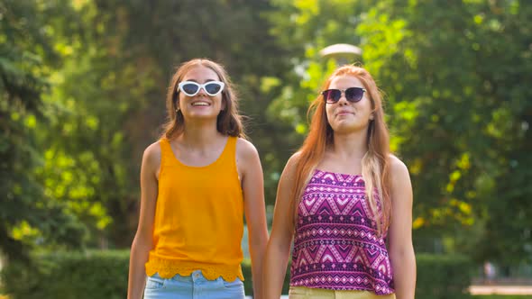 Teenage Girls or Friends Walking in Summer Park