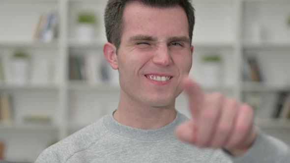 Portrait of Young Male Designer Pointing Finger at Camera 