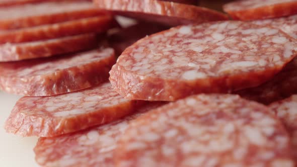 Pile of cured sausage of air-dried meat cuts slow pan 4K 2160p 30fps UltraHD footage - Tasty dry  sa