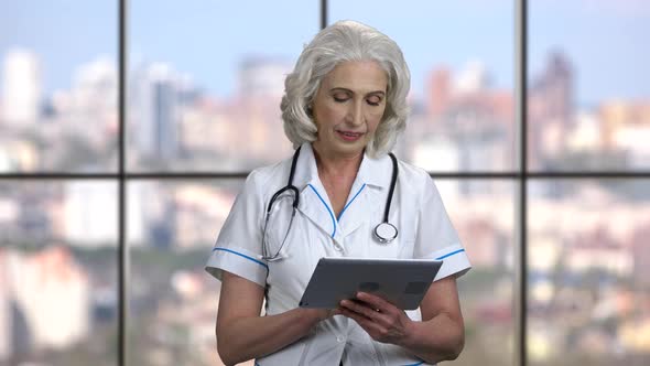 Mature Female Doctor Using Digital Tablet