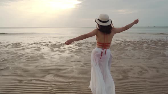 slow-motion of woman in bikini walking on the sea beach