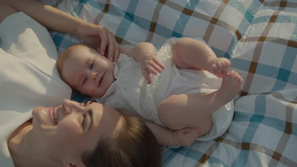 Mom Kisses Her Daughter and Laughs