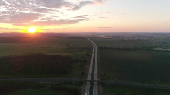 Aerial view of evening highway and fields at sunset 05