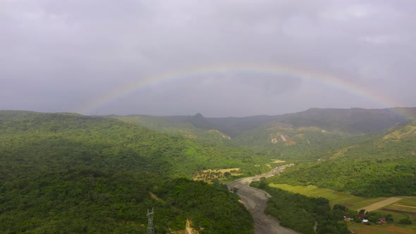 Rainbow in a Mountain Valley After Rain Top View