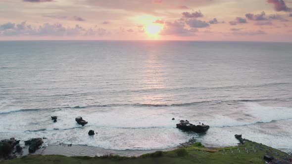 A Beautiful Landscape Shot From a Drone Flying Over the Coastline of Dark Ocean Reefs to a