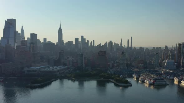 An aerial view of Manhattan's westside in the morning with the sun creating a silhouette of the Empi