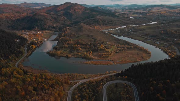 Aerial Drone View Above Winding Mountain Road Between Hills Curving River