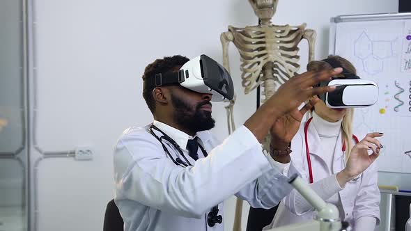 African American and Beautiful Blond Doctors Wearing Virtual Reality Headset