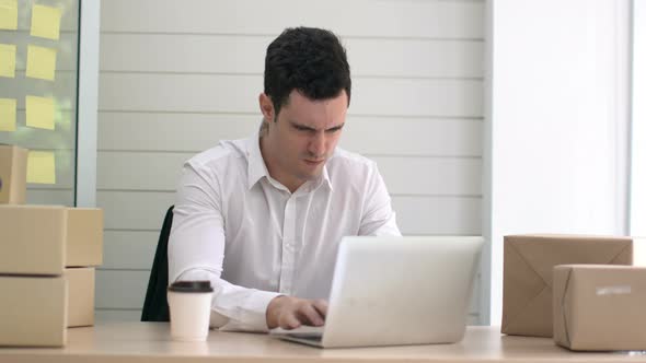 smart caucasian white collar staff working with laptop in delivery business at office