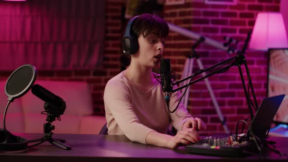 Portrait of Woman with Headphones Smiling While Broadcasting Talkshow Using Professional Microphone