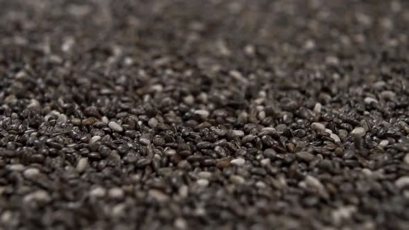 Chia seeds fall in a heap and rotate