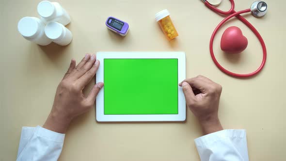 Doctor in White Coat is Using a Digital Tablet Top Down