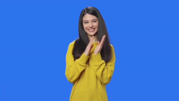 Portrait of Pretty Brunette Clapping Her Hands Happily