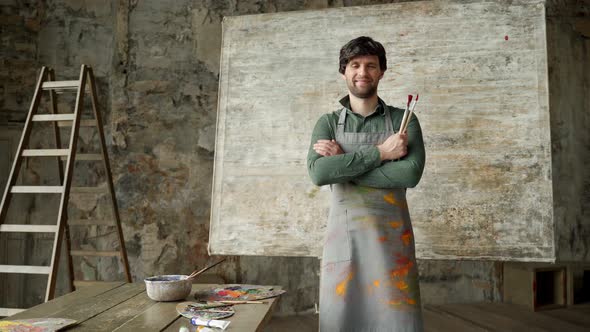 Portrait of Man Artist Working on Painting in Studio