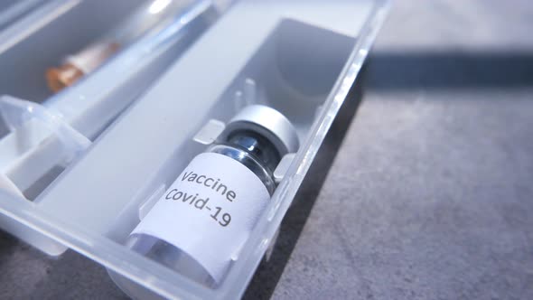 Close Up of Coronavirus Vaccine and Syringe in a Box 