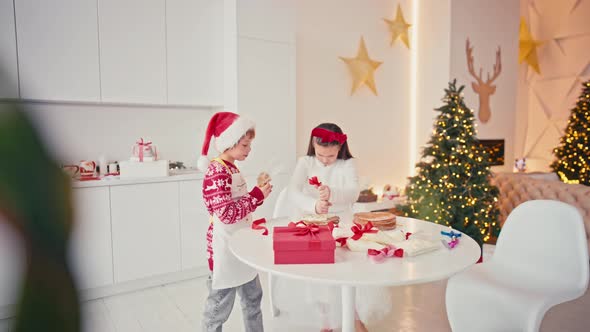 Happy Kids Girl and Boy Making Homemade Cake for Christmas at Light Home Interior