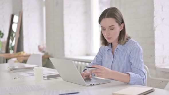 Cheerful Woman Reacting To Online Payment Failure in Office