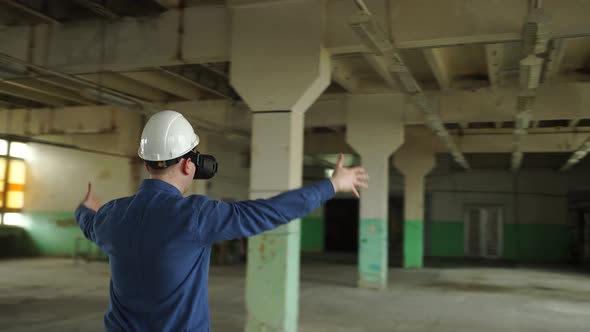 An Engineer Wearing Virtual Reality Glasses Moves Digital Objects with His Hands