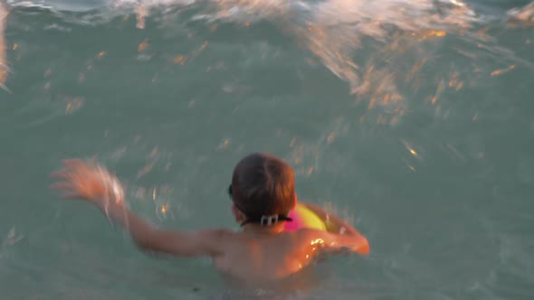  - Child Bathing in the Sea and Catching Strong Waves