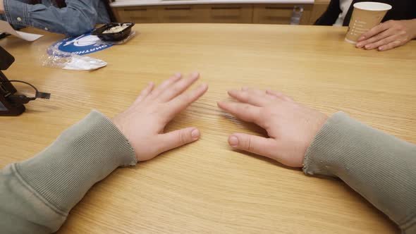 Male Hands are on the Table and Fingers are Knocking