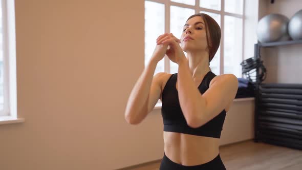 4x Slow Motion Video of Beautiful Young Woman Working Out and Stretching Indoors