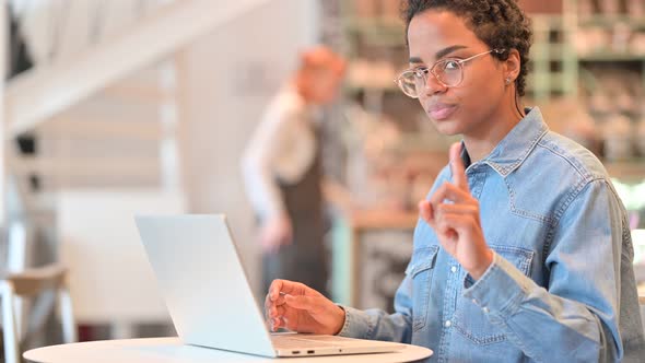 Young African Woman with Laptop Saying No with Finger 