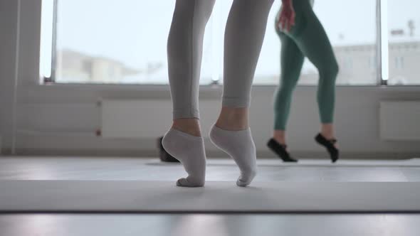 Closeup of a Female Ballerina Walking on Socks Without Pointe Shoes