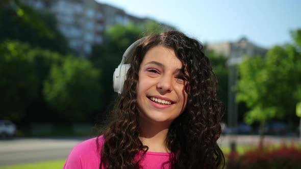 Portrait of Beautiful Girl Woman Curly Black Hair with Headphones Outside