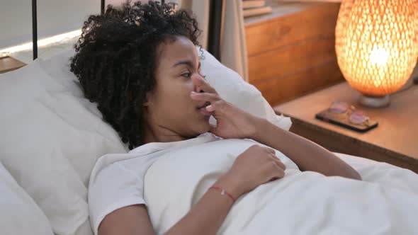 Young African Woman Waking Up From Nightmare in Bed 