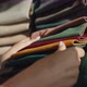 The Buyer Chooses the Fabric in the Textile Store the Seller Holds Samples with Multicolored Fabric - VideoHive Item for Sale
