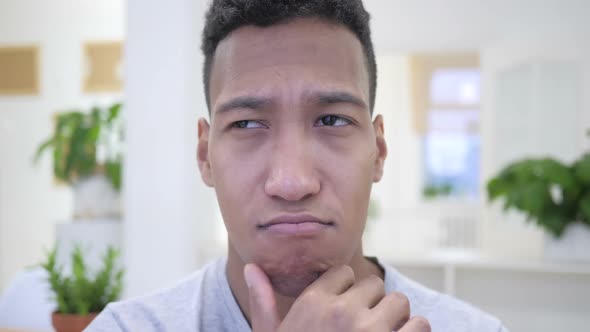 Thinking Pensive African Young Man Brainstorming