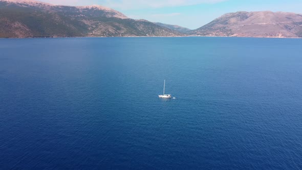 Aerial view near  the Antisamos beach with clear water and sailing boat