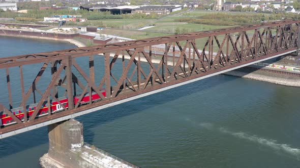 Commuter Train Passing Over an Old Iron Bridge