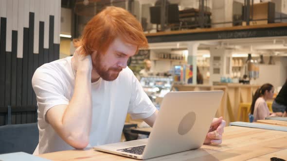 Tired Redhead Beard Man Working in Cafe