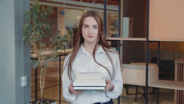 Portrait of a Schoolboy of the Senior Classes with Books in Hands in a School Class