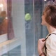 Young Woman Walks Around the City and Looks at the Shop Windows - VideoHive Item for Sale