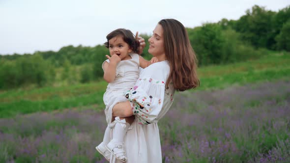 Mother Playing with Baby Girl in Lavender Field