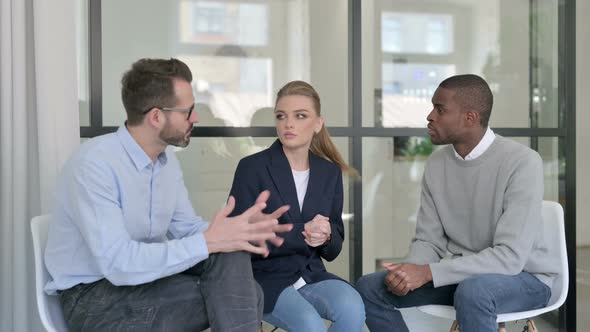 Businessman African Businessman and Young Woman Talking in Office