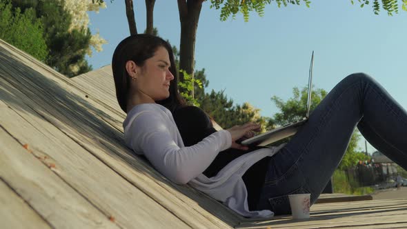 Young Woman Working On A Laptop In A Chill-Out Area 