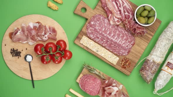 Vertical video, Close-up: cold cuts, salami, prosciutto, jamon, cherry tomatoes, sliced ​​sausage