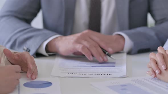 Close up of Hands of Business People Discussing Reports