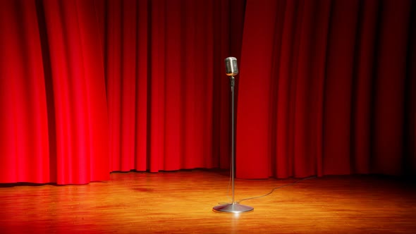 A vintage microphone on the empty stage. Old classic mic in the theatre. Show.