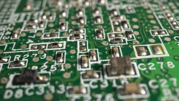 Extreme Closeup of Green Printed Circuit Board Electronics Shot with Dolly